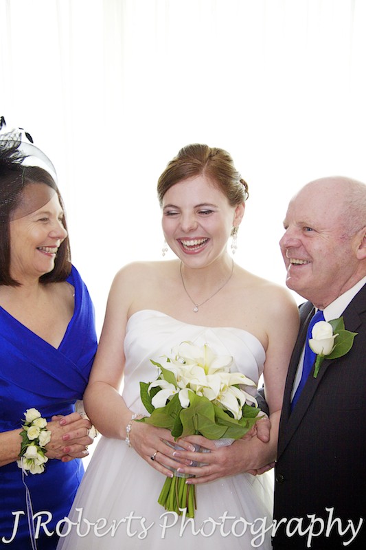 Bride laughing with her parents - wedding photography sydney
